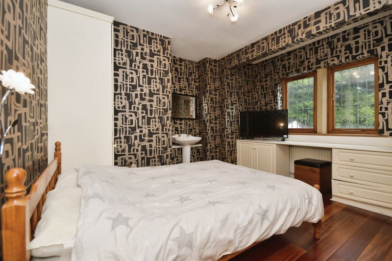 "With two rear facing double glazed windows. This bedroom benefits from various fitted bedroom furniture and a wash hand basin with pedestal. With wooden flooring and a central heating radiator."