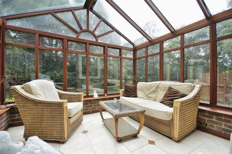 Fully glazed with side facing door leading to almost an acre of private garden and woodland."