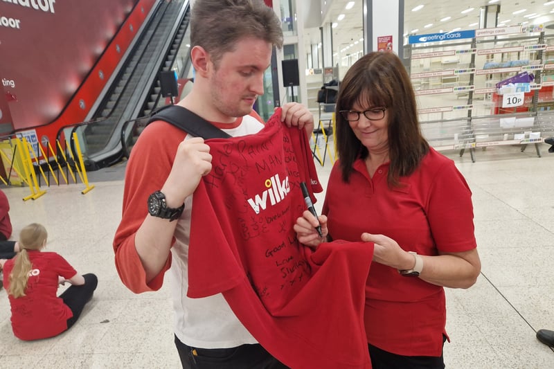 Members of staff - some of whom have been with the company or even the store as many as 10 or 20 years - signed each others Wilko shirts to see each other off.