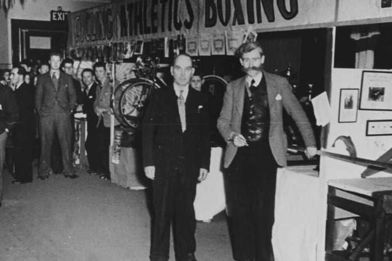 Two gentleman pose for a picture at the Sports Exhibition in Kirkintilloch Town Hall, 1953. Sports teams were the pride of the town and included cycling, athletics, boxing, football, and more. While of no particular historical significance, note the mutton chops on the fella on the right - incredible stuff.