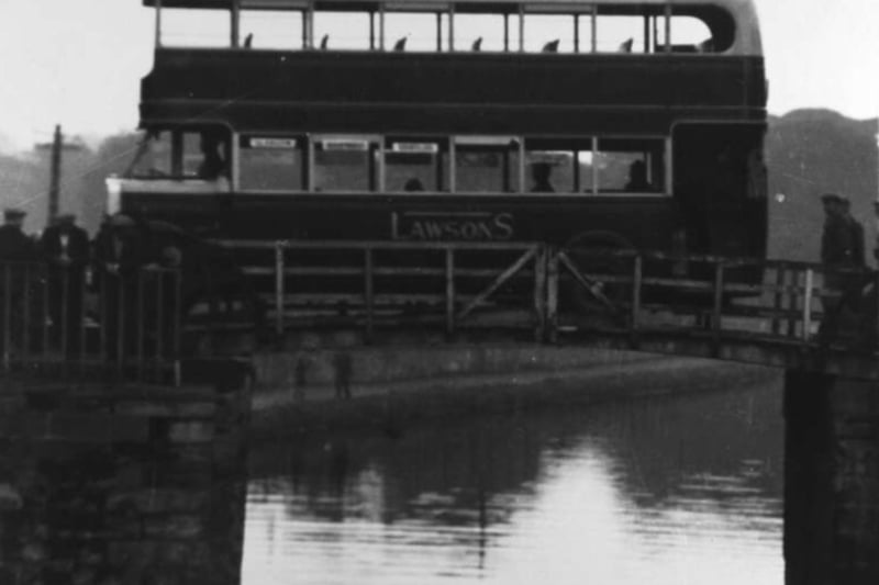 An old Lawson’s bus crossing Townhead Canal Bridge, Kirkintilloch. One of a series taken by Provost William Fletcher during the 1920s and early 1930s which show how progressive growth in the size of motor buses was causing acute damage to the bascule bridge at Townhead. We’d like to see the X85 try and get over this crossing.