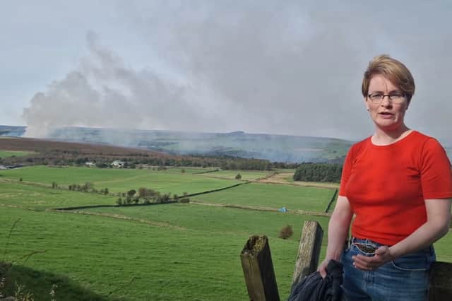 Lodge Moor resident Alice Puritz-Evans with the smoke from Redmires on October 9.