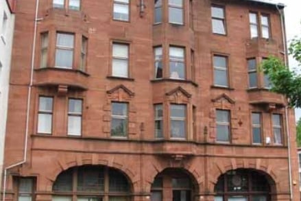 This tenement building is one of the few survivors of the 1960s redevelopment scheme in what used to be known as Pollok Street. It was built in 1902 for John Campbell Esq. and provided accommodation for the Commercial Bank of Scotland which had formerly been housed in the Toonhouse building and Prentice and Frew solicitor’s office, with six dwellings above. The Commercial Bank of Scotland merged with the National Bank of Scotland in 1959 and subsequently with the Royal  Bank of Scotland in 1969. During the Clydeside blitz of 13th and 14th of March 1941 an unexploded bomb landed behind the building, but it was safely defused and removed. In the 1960s there was an attempted robbery at the bank when a firearm was discharged. Fortunately no one was wounded, but a bullet hole was visible in the ceiling. The building is now residential flats.