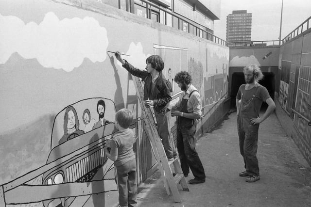 Andrew Carter, right, and Martin Weston, second right, had a helping hand from youngsters on holiday when they transformed a subway into an outside art gallery in 1979.