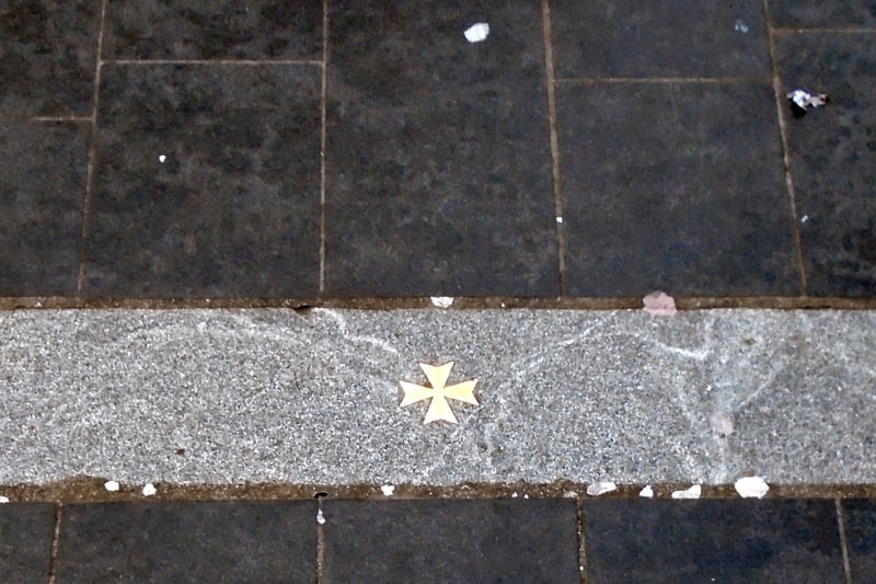 This brass Maltese cross outside the entrance to Keys Court, on Church Street, marks the site of the former St Peter’s Church.