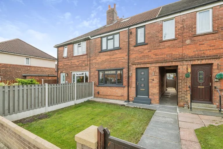 This charming terraced home with gardens to the front and rear is on the market.