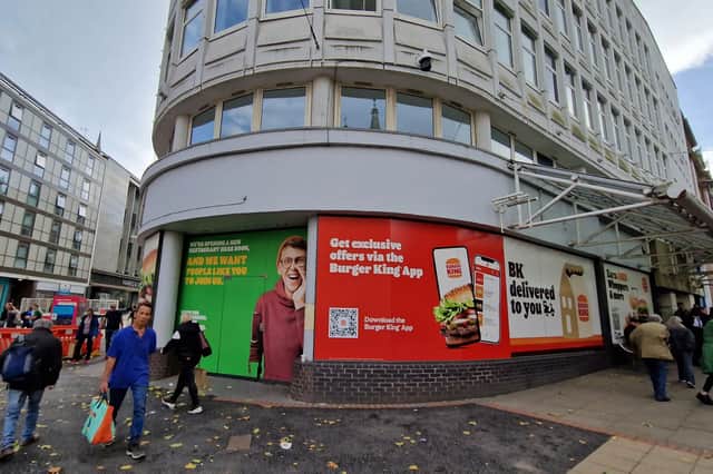 The fast-food giant has plastered the windows of its forthcoming restaurant with brightly coloured adverts. 