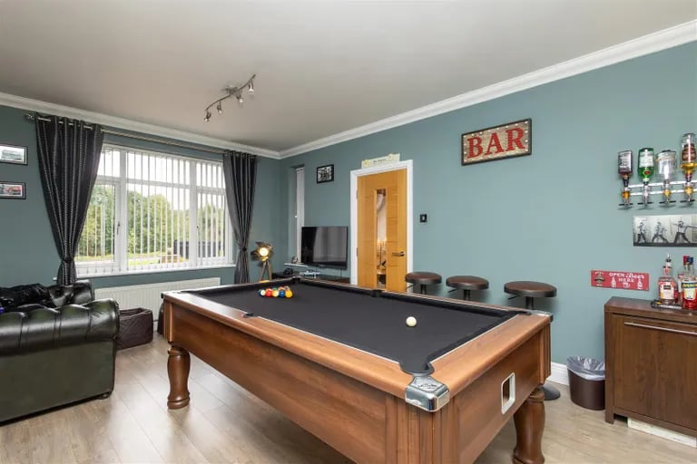 A games room sits to the front and is a perfect place to relax with friends and family.