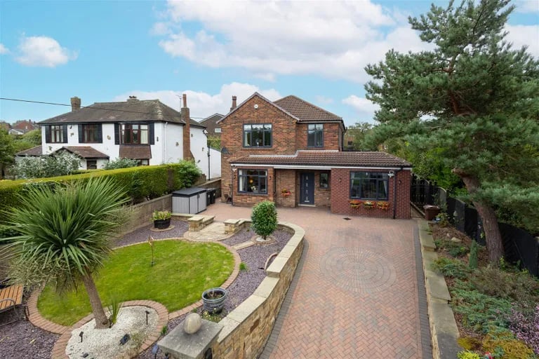 This stunning property has a small front garden and a large driveway to the front.