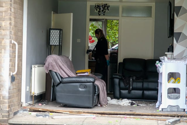 A police officer can be seen inside the ground floor property on St Lawrence Road.