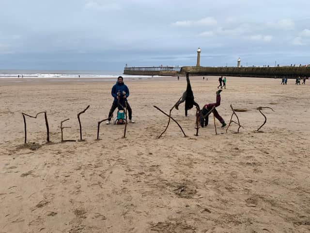 "Merry Xmas": On their last Christmas as a family, the Smiths built a festive message on the beach from driftwood.