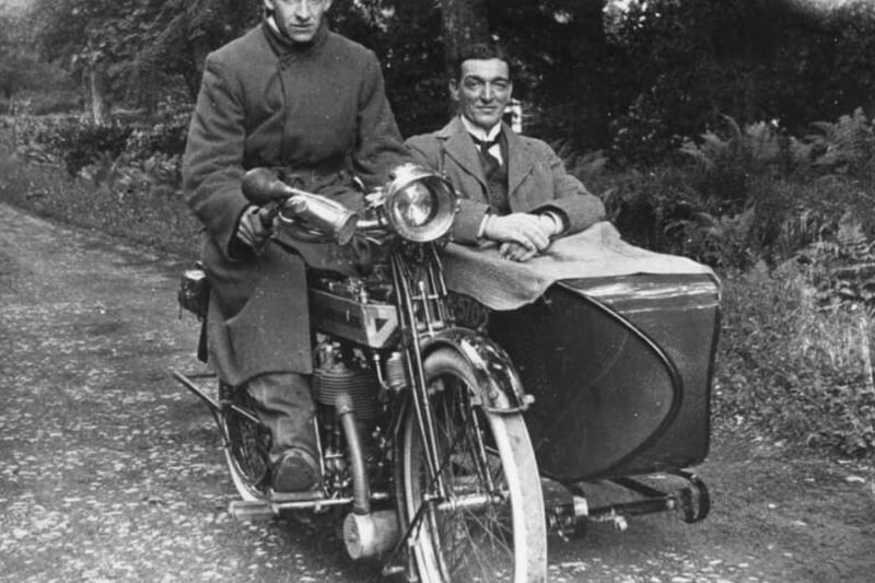 An early motorbike with a sidecar passenger looking very pleased with himself. Given the motorbike we can place this in the early 20th century, although the exact date is unknown as the East Dunbartonshire archives were given the image from a glass negative found in a house in Bishopbriggs.