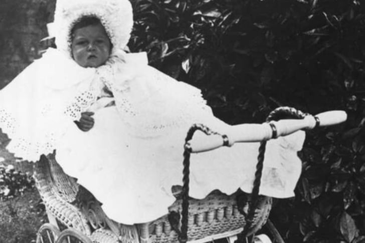 A bonnie baby in a bonnet, judging from the style of pram, with the large overlapping Victorian wheels, we could date this around image around the early 20th century.