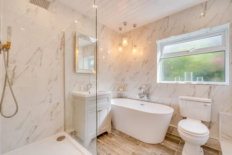 The family bathroom has a stunning bathtub and separate walk-in shower.