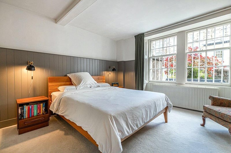 Second double bedroom with stylish wall panelling, garden aspect windows and fitted mirrored wardrobes. 