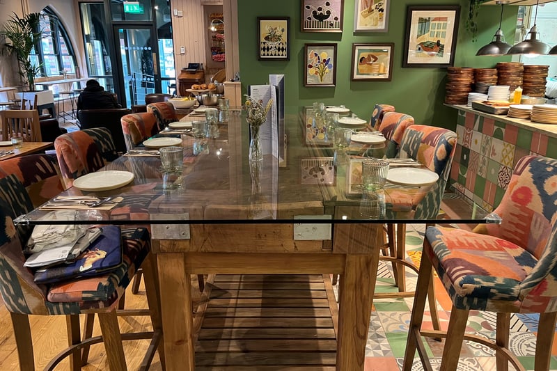 The large table in front of the kitchen has been made from an old butcher’s block