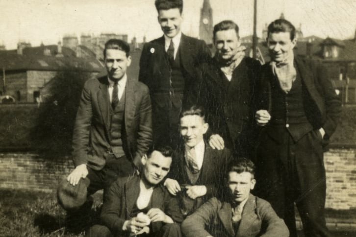 These seven well-dressed young men are posing for a photo inside the grounds of the Summerlee Iron Works in Coatbridge - close to the garden of Summerlee Gatehouse.