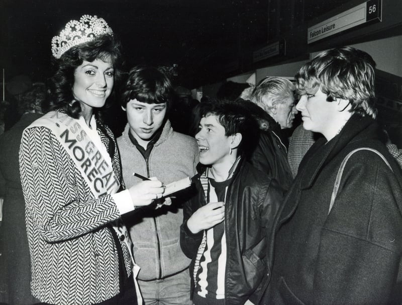 Miss Great Britain Jill Saxby signs autographs for admiring young fans at a 1985 holiday and travel exhibition held at the Cutler's Hall in Sheffield
