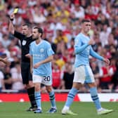  Match Referee Michael Oliver shows a yellow card to Mateo Kovacic of Manchester City during the Premier League match between Arsenal FC and Manchester City at Emirates Stadium  (Photo by Alex Pantling/Getty Images)
