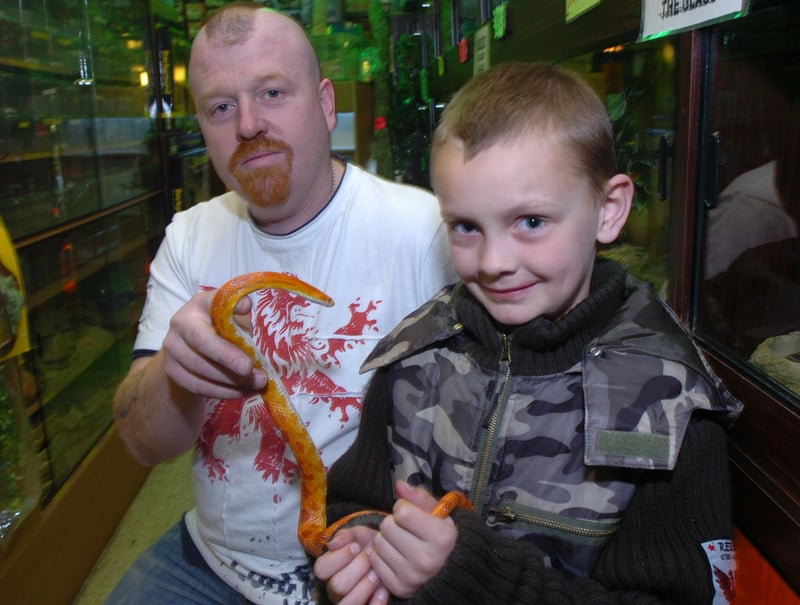 Tony Howarth, owner of Sheffield Exotics pet shop, on Attercliffe Road, Sheffield, presents eight-year-old Jordan Wharmsby with a corn snake. Jordan's snake had died when power to its tank was accidentally turned off.