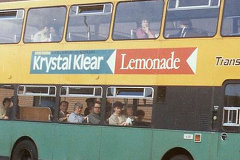 An old-school retro bus in Paisley during the mid 20th century, on the side we can see an advertisement for Krystal Klear lemonade, brewed in the nearby Renfrewshire town of Lochwinnoch for over 100 years by Struthers.
