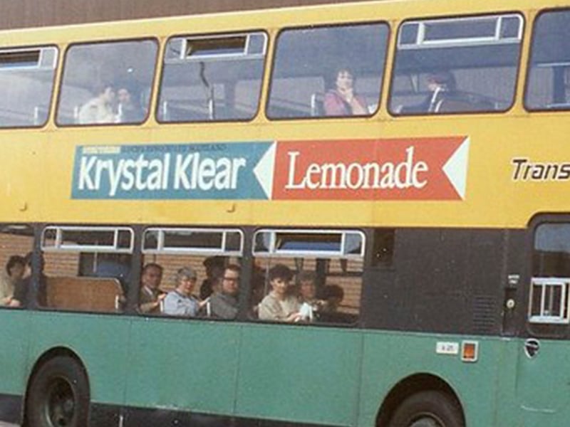 An old-school retro bus in Paisley during the mid 20th century, on the side we can see an advertisement for Krystal Klear lemonade, brewed in the nearby Renfrewshire town of Lochwinnoch for over 100 years by Struthers.