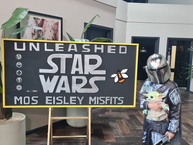 A young Mandalorian with Grogu.