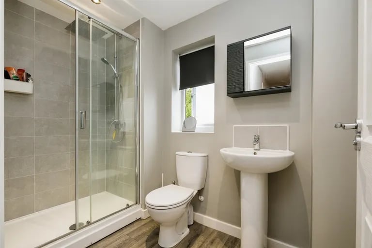 The ensuite has a wash hand basin, WC and large walk-in shower.