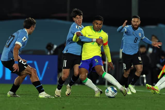 Uruguay's midfielder Facundo Pellistri (L) and Brazil's midfielder Casemiro (R) fight for the ball during the 2026 FIFA World Cup South American qualification football match between Uruguay and Brazil at the Centenario Stadium in Montevideo