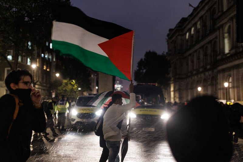Amid heavy rain on Wednesday evening, protesters gathered in Westminster holding signs that read "stop the massacre" and "stop bombing Gaza".
