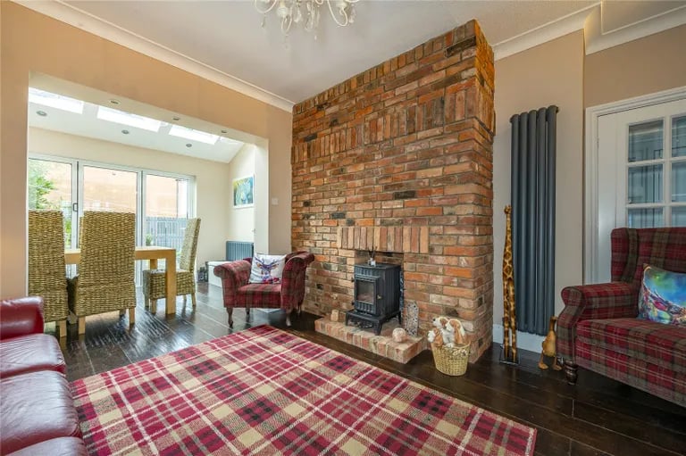 In the lounge is a fireplace and a brick wall.