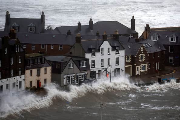 Waves crash over the harbour on October 19, 2023 in Stonehaven, Scotland.