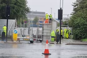 A flood barrier is erected on Meadowhall Drive in Sheffield as river levels continue to rise during Storm Babet