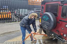 Nadia attaches a tow rope to her Land Rover