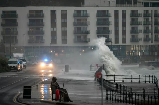 Waves crash near to the 'Freddie Gilroy' sculpture by artist Ray Lonsdale in Scarborough, as Storm Babet batters the country.