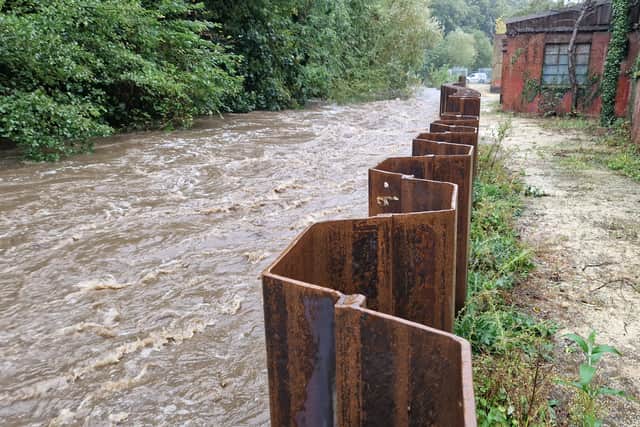 New flood defences keep out the River Loxley behind Towsure in Malin Bridge