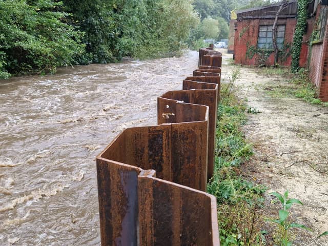 New flood defences keep out the River Loxley behind Towsure in Malin Bridge