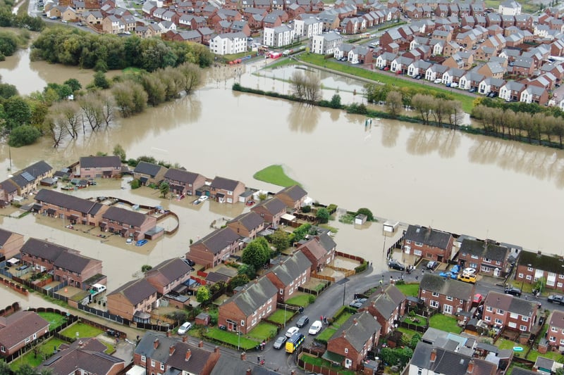 The view of Catcliffe from above is a worrying picture for those in the Rotherham village, showing cars partly submerged and the water coming up above the level of doors to many homes. (Picture: Alex Booth)