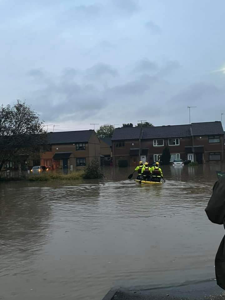 South Yorkshire Fire and Rescue in Catcliffe on a boat to rescue residents trapped in their homes.
