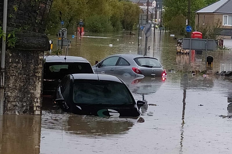 Two feet of flood water can float a car, and these vehicles have been submerged in the deep water.