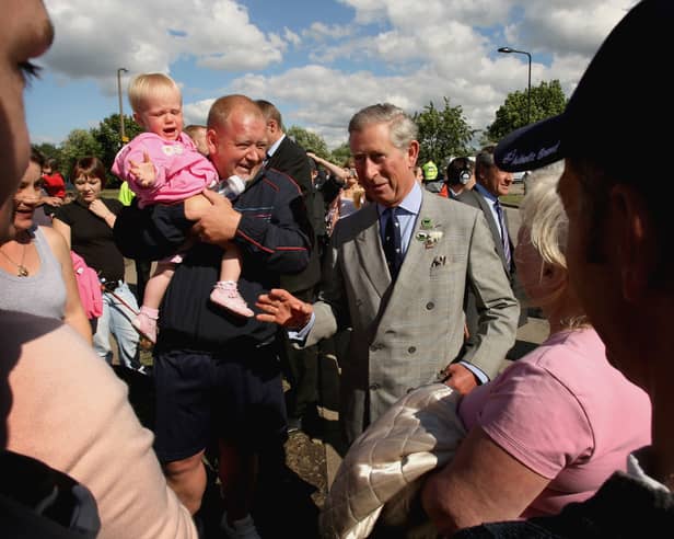 Prince of Wales speaks with local residents during a visit to flood effected areas on June 29, 2007 in Catcliffe near Sheffield. (Photo by Daniel Berehulak/Getty Images)
