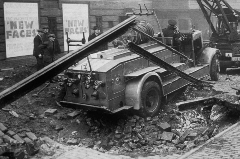 A fire engine which crashed into a bomb crater during an night-time air raid in Liverpool in 1940.