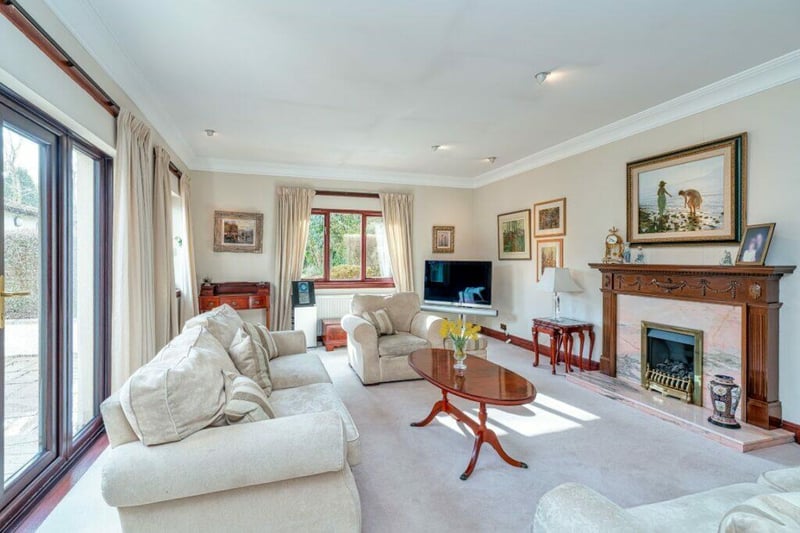 The living room of the property boasts a hearth fire and access to the rear garden