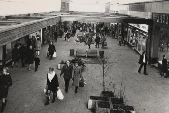Black and white photograph of people shopping on a street on Regent Way before the roof was put on. 
