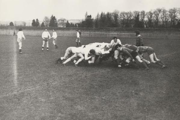 Black and white photograph of scrum in a rugby match