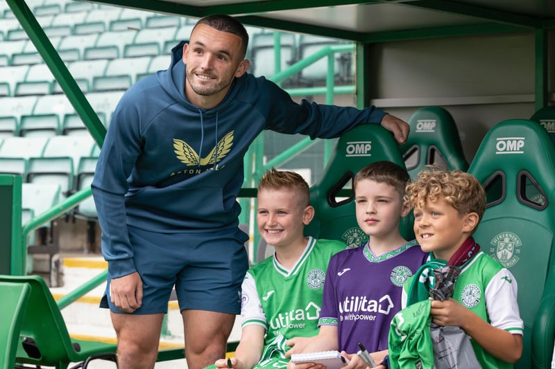 Three young fans pose for a picture with Scotland international and former Hibee John McGinn.