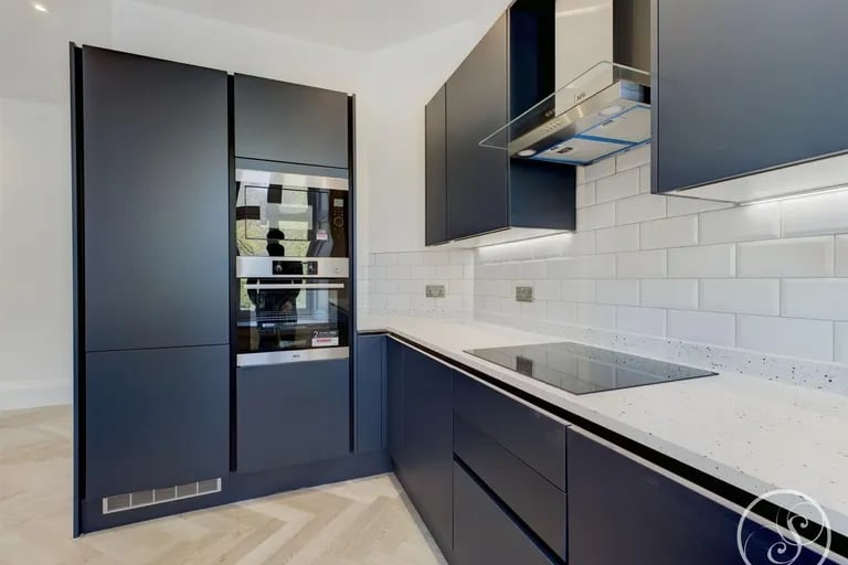 A bright and modern fitted kitchen with integrated appliances.
