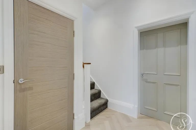 A spacious hallway welcomes you into this duplex.