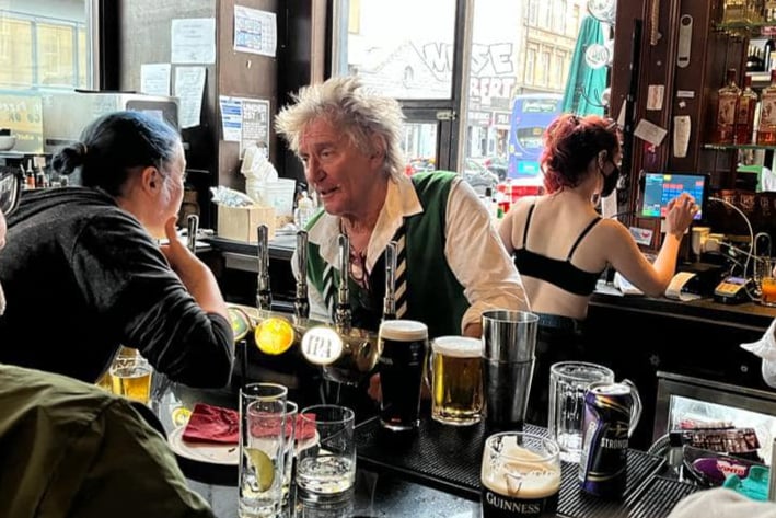 The rock star popped into the Dirty Duchess in Finnieston to help pour a few pints after attending the football earlier that day. 