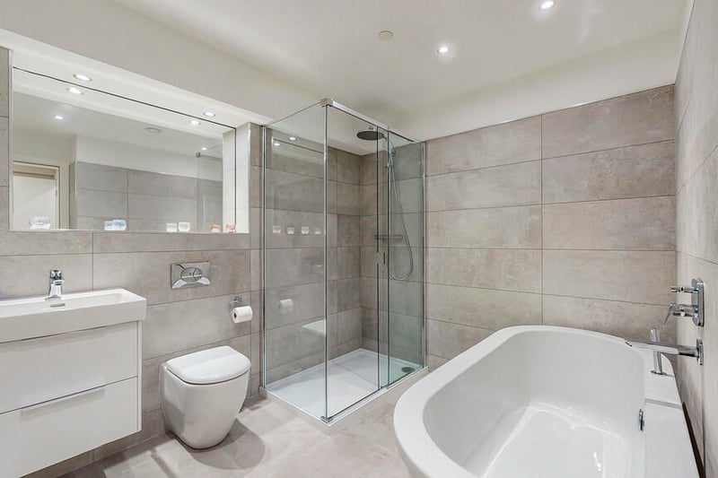 The large main bathroom is fitted with a stylish four-piece suite including a freestanding bath. 